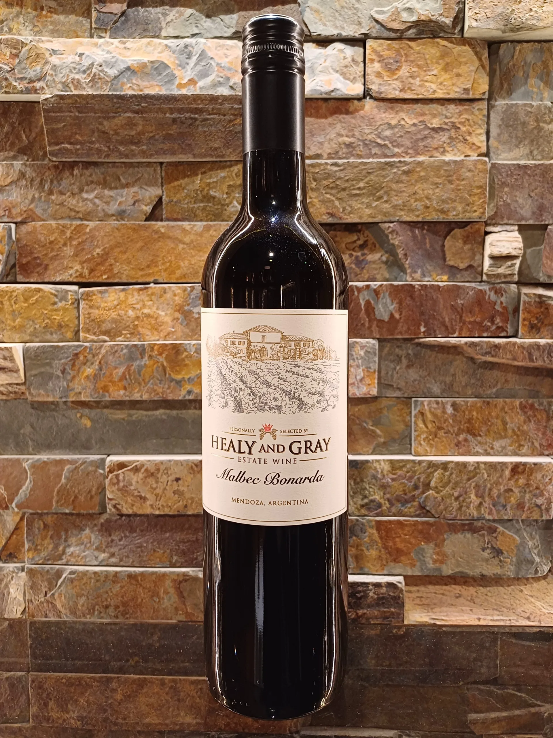 The Healy & Gray Estate Malbec Bonarda is a splendid red wine hailing from the esteemed Mendoza region in Argentina, Spain, where the high-altitude vineyards produce exceptional quality grapes. This wine greets you with a deep, intense red-violet hue, immediately captivating the eye.