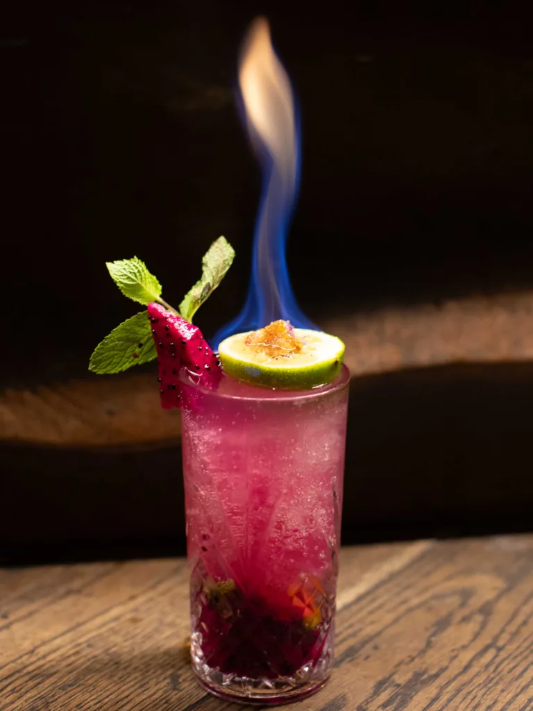 Dragonfruit Mojito Cocktail - This visually spectacular mojito layers the classic cool mint and zesty lime with a subtle tropical fruitiness, all underpinned by a surprisingly deep and warm vanilla-spice finish from the rum.