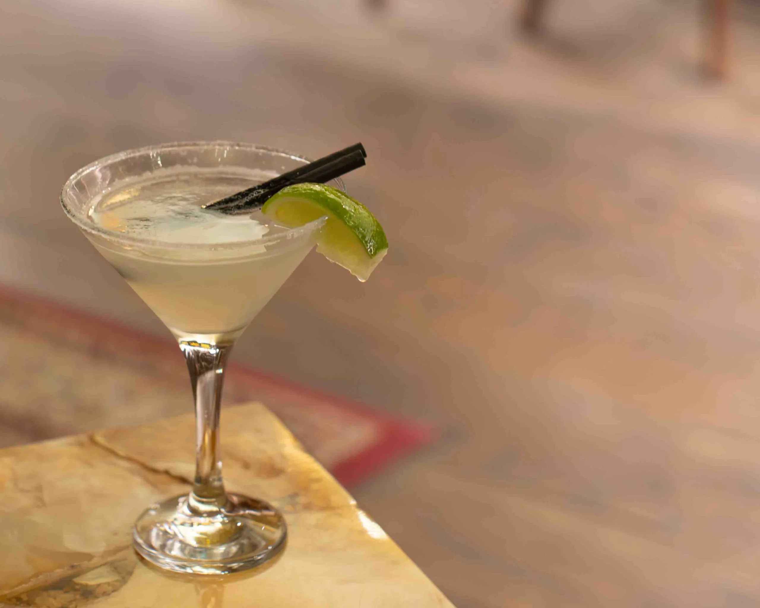 The Ross Margarita opens with a crisp, zesty burst of fresh lime that wakes up the palate, sharp and tangy with bright citrus acidity. The Volcán Blanco tequila brings a clean, peppery agave character beneath it, all earthy crispness and a subtle vegetal warmth that gives the drink its backbone.