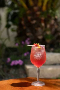 Mrs P's Jam Spritz is a bright, jammy strawberry-and-yuzu spritz — sweet and fruity up front, balanced by crisp prosecco and soda, with a floral, citrusy garnish