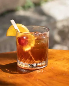The Rum Sour is a warmly spiced, citrus-forward classic — sweet spiced rum balanced by sharp lemon and lime, smoothed with syrup and finished with a fragrant orange and cherry garnish.