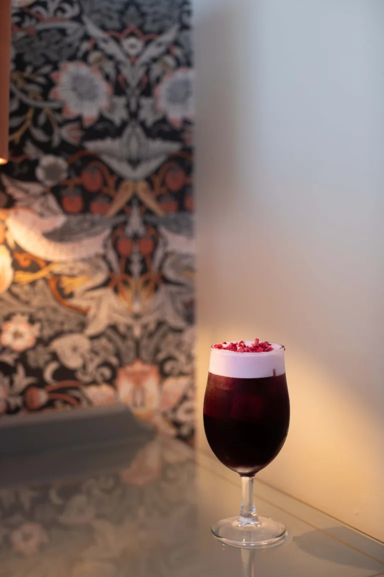 Blood Moon Cocktail - A deep red Malbec cocktail named for its eclipse-dark hue: dark berry wine, bright raspberry vodka, soft peach schnapps and tart pomegranate syrup, rich, fruity and glowing garnet.