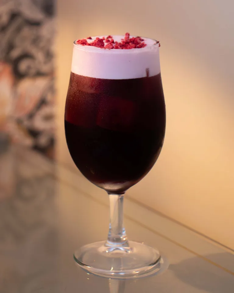 Blood Moon Cocktail - A deep red Malbec cocktail named for its eclipse-dark hue: dark berry wine, bright raspberry vodka, soft peach schnapps and tart pomegranate syrup, rich, fruity and glowing garnet.