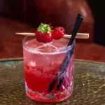 Cherry Daiquiri Cocktail lifted by dark cherry: sharp lime and sugar, ripe black cherry depth, and warm rum, hard-shaken and ice-cold, finishing short, clean and fruity.