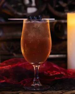 Midnight Mirage Cocktail - A long, cooling gin and tonic of floral elderflower, deep blueberry and fresh lemon, finished with crisp tonic: dusky purple, fragrant and refreshing, a twilight serve for warm Cornish evenings.