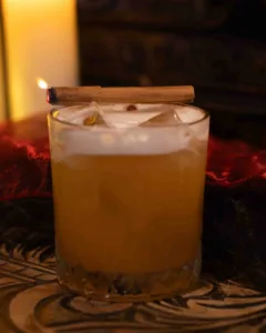 The Alchemist cocktail - A dark rum sour with pineapple, lime and warm cinnamon: tropical sweetness, bright citrus and gentle spice, rounded by aromatic bitters and finishing smooth, spiced and long.