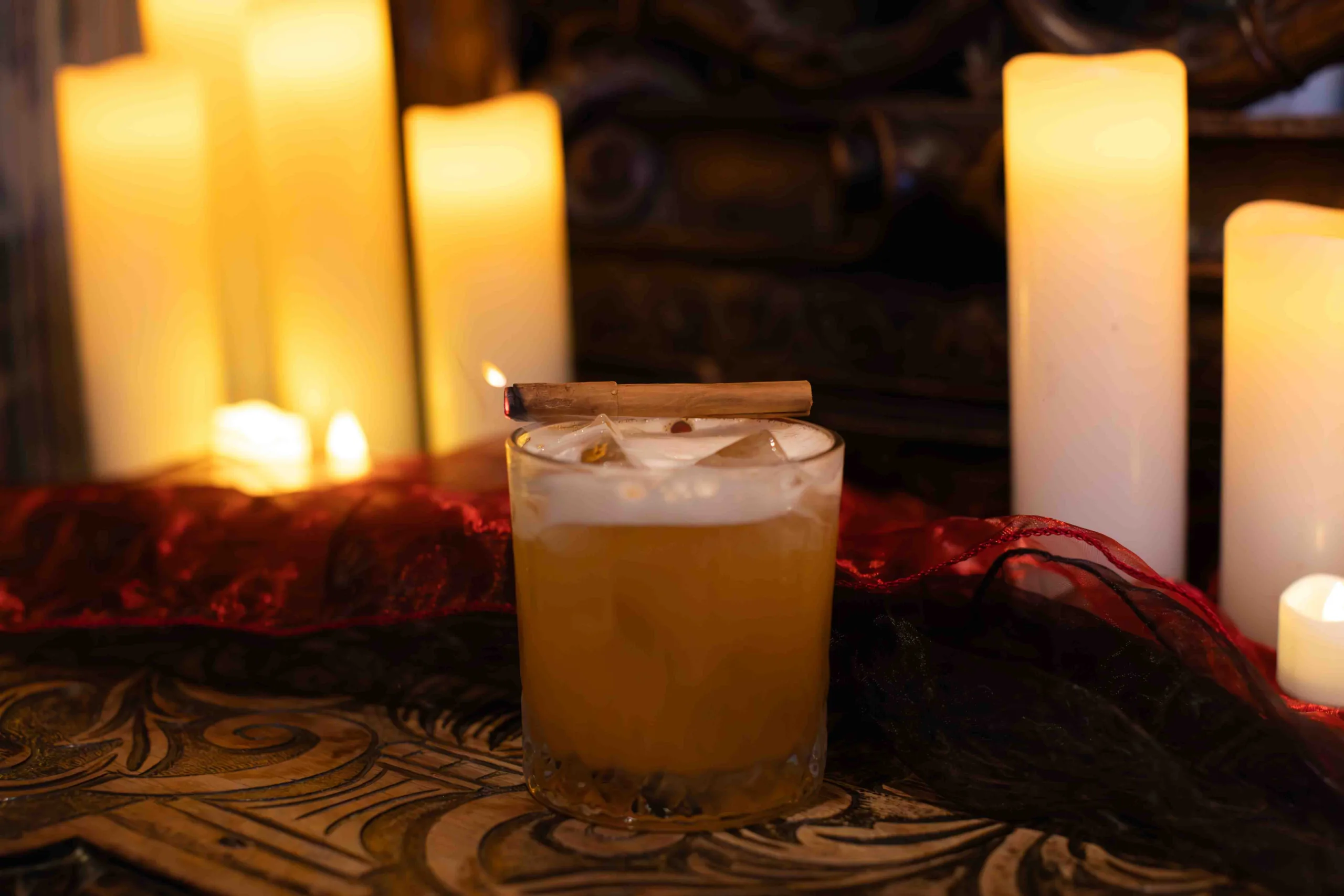 The Alchemist cocktail - A dark rum sour with pineapple, lime and warm cinnamon: tropical sweetness, bright citrus and gentle spice, rounded by aromatic bitters and finishing smooth, spiced and long.